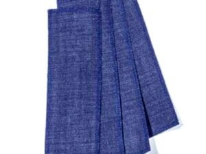 An assortment of cut denim strips ready to be included in sugaring wax + sugar scrub bundles and starter kit orders.
