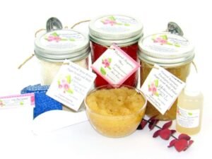 The bundle includes an 8 oz mason jar filled with soft sugaring wax, a jar of Rosemary Eucalyptus Herbal Sugar Body Scrub, and Colloidal Oatmeal Brown Sugar Dry Body Scrub, a small bottle of pure aloe vera, a pouch of cornstarch, denim strips, an applicator, and a glass bowl showcasing the sugar scrub, garnished with sprinkles of rosemary and a sprig of eucalyptus.