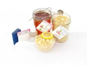 The bundle includes an 8 oz mason jar filled with soft sugaring wax, a jar of Coconut Lemon Sugar Body Scrub, a small bottle of pure aloe vera, a pouch of cornstarch, denim strips, an applicator, and a glass bowl showcasing the sugar scrub, garnished with coconut shavings and a slice of lemon.