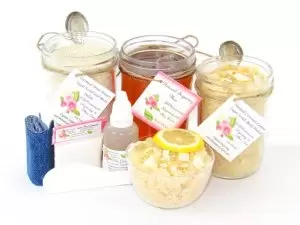 The bundle includes an 8 oz mason jar filled with soft sugaring wax, a jar of Coconut Lemon Sugar Body Scrub, and Colloidal Oatmeal Brown Sugar Dry Body Scrub, a small bottle of pure aloe vera, denim strips, a pouch of cornstarch, an applicator, and a glass bowl showcasing the sugar scrub, garnished with coconut shavings and a slice of lemon.
