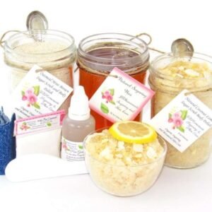 The bundle includes an 8 oz mason jar filled with soft sugaring wax, a jar of Coconut Lemon Sugar Body Scrub, and Colloidal Oatmeal Brown Sugar Dry Body Scrub, a small bottle of pure aloe vera, denim strips, a pouch of cornstarch, an applicator, and a glass bowl showcasing the sugar scrub, garnished with coconut shavings and a slice of lemon.