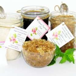 The bundle includes an 8 oz mason jar filled with firm sugaring paste, a jar of Peppermint Coconut Sugar Body Scrub, and Colloidal Oatmeal Brown Sugar Dry Body Scrub, a small bottle of pure aloe vera, a pouch of cornstarch, an applicator, and a glass bowl showcasing the sugar scrub, garnished with coconut shavings and a sprig of fresh mint.