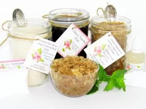 The bundle includes an 8 oz mason jar filled with firm sugaring paste, a jar of Peppermint Coconut Sugar Body Scrub, and Colloidal Oatmeal Brown Sugar Dry Body Scrub, a small bottle of pure aloe vera, a pouch of cornstarch, an applicator, and a glass bowl showcasing the sugar scrub, garnished with coconut shavings and a sprig of fresh mint.