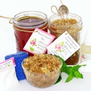 The bundle includes an 8 oz mason jar filled with soft sugaring wax, a jar of Peppermint Coconut Sugar Body Scrub, a small bottle of pure aloe vera, a pouch of cornstarch, denim strips, an applicator, and a glass bowl showcasing the sugar scrub, garnished with coconut shavings and a sprig of fresh mint.