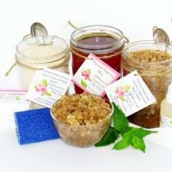 The bundle includes an 8 oz mason jar filled with soft sugaring wax, a jar of Peppermint Coconut Sugar Body Scrub, and Colloidal Oatmeal Brown Sugar Dry Body Scrub, a small bottle of pure aloe vera, a pouch of cornstarch, denim strips, an applicator, and a glass bowl showcasing the sugar scrub, garnished with coconut shavings and a sprig of fresh mint.