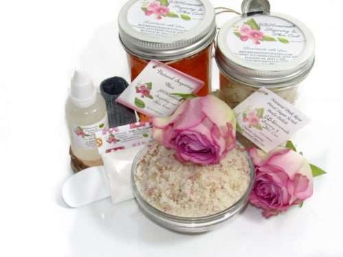 The set includes an 8 oz mason jar filled with soft sugaring wax, a jar of Pink Rose Petal Sugar Body Scrub, the included applicator, bottle of pure aloe vera, denims strips and a glass bowl showcasing the sugar scrub, garnished with a pink rose bloom.
