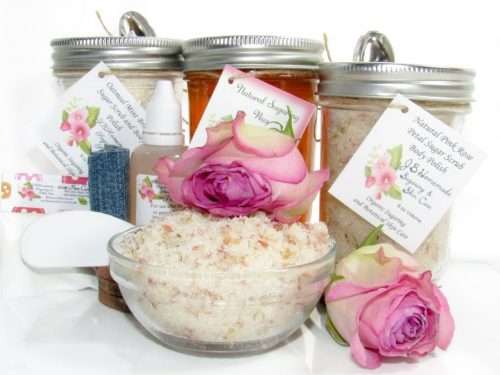 The bundle includes an 8 oz mason jar filled with soft sugaring wax, a jar of Pink Rose Petal Sugar Body Scrub, and Colloidal Oatmeal Brown Sugar Dry Body Scrub, a small bottle of pure aloe vera, a pouch of cornstarch, denim strips, an applicator, and a glass bowl showcasing the sugar scrub, garnished with a pink rose bloom.