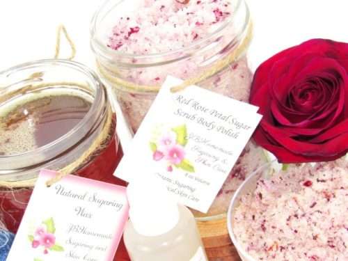 The bundle includes an 8 oz mason jar filled with soft sugaring wax, a jar of Red Rose Petal Sugar Body Scrub, the included applicator, bottle of pure aloe vera, denims strips and a glass bowl showcasing the sugar scrub, garnished with a red rose bloom.