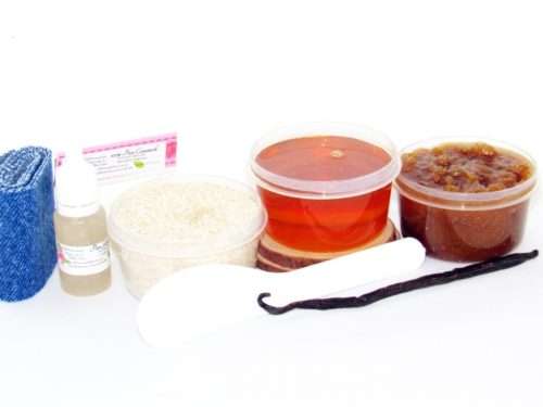 The home sugaring hair removal starter kit comes with a 2 oz tub of soft sugaring wax, a tub of Vanilla Aloe Brown Sugar Body Scrub, a tub of Colloidal Oatmeal Brown Sugar Dry Body Scrub, a small bottle of pure aloe vera, a pouch of cornstarch, denim strips, an applicator, along with a vanilla bean for illustration.