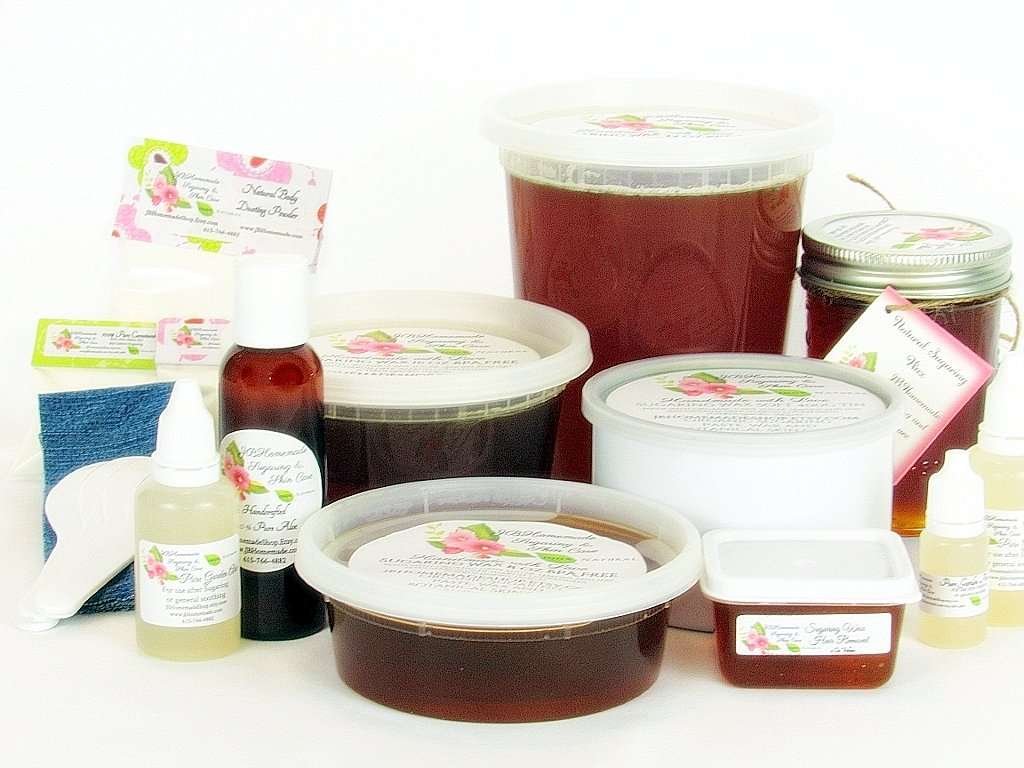 A variety of JBHomemade sugaring wax containers, pure aloe vera bottles, cornstarch pouches, applicators, and denim strips for complete skin care. The image showcases a collection of JBHomemade Sugaring Wax in various container sizes including tubs and masons alongside bottles of pure garden-fresh aloe vera, pouches of cornstarch, applicators, and denim strips arranged aesthetically against a white background. The assortment includes 16 Oz (two half pint masons), 16 Oz Tub, 24 Oz (3 half pink masons), 2 Oz tub, 32 Oz tub, a 400g Tin, 8 Oz mason, and an 8 oz tub. The aloe vera bottles provide soothing aftercare, while the cornstarch pouches are used for skin preparation. Applicators and denim strips complete this comprehensive collection for effective and natural hair removal. 🌸
