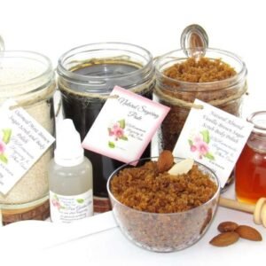 The bundle includes an 8 oz mason jar filled with firm sugaring paste, a jar of Almond Vanilla Brown Sugar Body Scrub, and Colloidal Oatmeal Brown Sugar Dry Body Scrub, a small bottle of pure aloe vera, a pouch of cornstarch, an applicator, and a glass bowl showcasing the sugar scrub, garnished with sprinkled almonds and a small glass jar of raw honey.