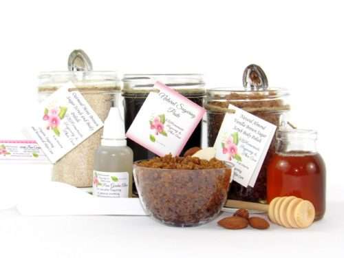 The bundle includes an 8 oz mason jar filled with firm sugaring paste, a jar of Almond Vanilla Brown Sugar Body Scrub, and Colloidal Oatmeal Brown Sugar Dry Body Scrub, a small bottle of pure aloe vera, a pouch of cornstarch, an applicator, and a glass bowl showcasing the sugar scrub, garnished with sprinkled almonds and a small glass jar of raw honey.