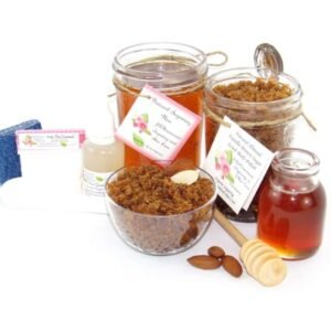 The bundle includes an 8 oz mason jar filled with soft sugaring wax, a jar of Almond Vanilla Brown Sugar Body Scrub, a small bottle of pure aloe vera, a pouch of cornstarch, denim strips, an applicator, and a glass bowl showcasing the sugar scrub, garnished with sprinkled almonds and a small glass jar of raw honey.