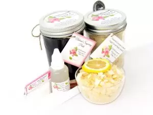 The bundle includes an 8 oz mason jar filled with firm sugaring paste, a jar of Coconut Lemon Sugar Body Scrub, a small bottle of pure aloe vera, a pouch of cornstarch, an applicator, and a glass bowl showcasing the sugar scrub, garnished with coconut shavings and a slice of lemon.