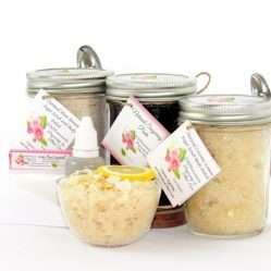 The bundle includes an 8 oz mason jar filled with firm sugaring paste, a jar of Coconut Lemon Sugar Body Scrub, and Colloidal Oatmeal Brown Sugar Dry Body Scrub, a small bottle of pure aloe vera, a pouch of cornstarch, an applicator, and a glass bowl showcasing the sugar scrub, garnished with coconut shavings and a slice of lemon.