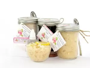 The bundle includes an 8 oz mason jar filled with firm sugaring paste, a jar of Coconut Lemon Sugar Body Scrub, and Colloidal Oatmeal Brown Sugar Dry Body Scrub, a small bottle of pure aloe vera, a pouch of cornstarch, an applicator, and a glass bowl showcasing the sugar scrub, garnished with coconut shavings and a slice of lemon.