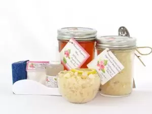 The bundle includes an 8 oz mason jar filled with soft sugaring wax, a jar of Coconut Lemon Sugar Body Scrub, a small bottle of pure aloe vera, a pouch of cornstarch, denim strips, an applicator, and a glass bowl showcasing the sugar scrub, garnished with coconut shavings and a slice of lemon.
