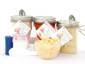 The bundle includes an 8 oz mason jar filled with soft sugaring wax, a jar of Coconut Lemon Sugar Body Scrub, and Colloidal Oatmeal Brown Sugar Dry Body Scrub, a small bottle of pure aloe vera, denim strips, a pouch of cornstarch, an applicator, and a glass bowl showcasing the sugar scrub, garnished with coconut shavings and a slice of lemon.