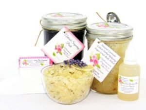 The bundle includes an 8 oz mason jar filled with firm sugaring paste, a jar of Lavender Lemon Herbal Relaxing Sugar Body Scrub, a small bottle of pure aloe vera, a pouch of cornstarch, an applicator, and a glass bowl showcasing the sugar scrub, garnished with a lavender sprig and a slice of lemon.