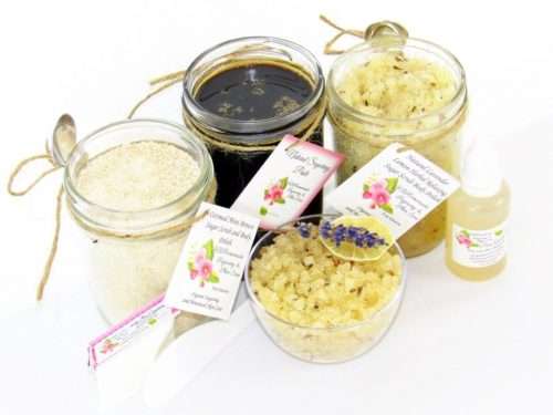 The bundle includes an 8 oz mason jar filled with firm sugaring paste, a jar of Lavender Lemon Herbal Relaxing Sugar Body Scrub, and Colloidal Oatmeal Brown Sugar Dry Body Scrub, a small bottle of pure aloe vera, a pouch of cornstarch, an applicator, and a glass bowl showcasing the sugar scrub, garnished with a lavender sprig and a slice of lemon.