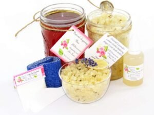 The bundle includes an 8 oz mason jar filled with soft sugaring wax, a jar of Lavender Lemon Herbal Relaxing Sugar Body Scrub, a small bottle of pure aloe vera, denim strips, a pouch of cornstarch, an applicator, and a glass bowl showcasing the sugar scrub, garnished with a lavender sprig and a slice of lemon.