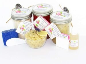 The bundle includes an 8 oz mason jar filled with soft sugaring wax, a jar of Lavender Lemon Herbal Relaxing Sugar Body Scrub, and Colloidal Oatmeal Brown Sugar Dry Body Scrub, a small bottle of pure aloe vera, a pouch of cornstarch, denim strips, an applicator, and a glass bowl showcasing the sugar scrub, garnished with a lavender sprig and a slice of lemon.
