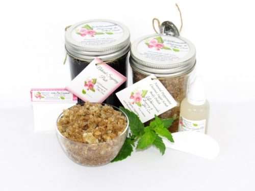 The bundle includes an 8 oz mason jar filled with firm sugaring paste, a jar of Peppermint Coconut Sugar Body Scrub, a small bottle of pure aloe vera, a pouch of cornstarch, an applicator, and a glass bowl showcasing the sugar scrub, garnished with coconut shavings and a sprig of fresh mint.