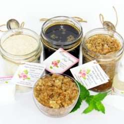 The bundle includes an 8 oz mason jar filled with firm sugaring paste, a jar of Peppermint Coconut Sugar Body Scrub, and Colloidal Oatmeal Brown Sugar Dry Body Scrub, a small bottle of pure aloe vera, a pouch of cornstarch, an applicator, and a glass bowl showcasing the sugar scrub, garnished with coconut shavings and a sprig of fresh mint.