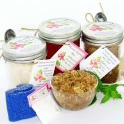 The bundle includes an 8 oz mason jar filled with soft sugaring wax, a jar of Peppermint Coconut Sugar Body Scrub, and Colloidal Oatmeal Brown Sugar Dry Body Scrub, a small bottle of pure aloe vera, a pouch of cornstarch, denim strips, an applicator, and a glass bowl showcasing the sugar scrub, garnished with coconut shavings and a sprig of fresh mint.