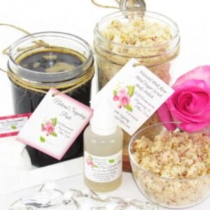 The set includes an 8 oz mason jar filled with firm sugaring paste, a jar of Pink Rose Petal Sugar Body Scrub, a small bottle of pure aloe vera, a pouch of cornstarch, an applicator, and a glass bowl showcasing the sugar scrub, garnished with a pink rose bloom.