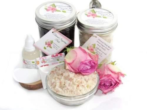 The set includes an 8 oz mason jar filled with firm sugaring paste, a jar of Pink Rose Petal Sugar Body Scrub, a small bottle of pure aloe vera, a pouch of cornstarch, an applicator, and a glass bowl showcasing the sugar scrub, garnished with a pink rose bloom.