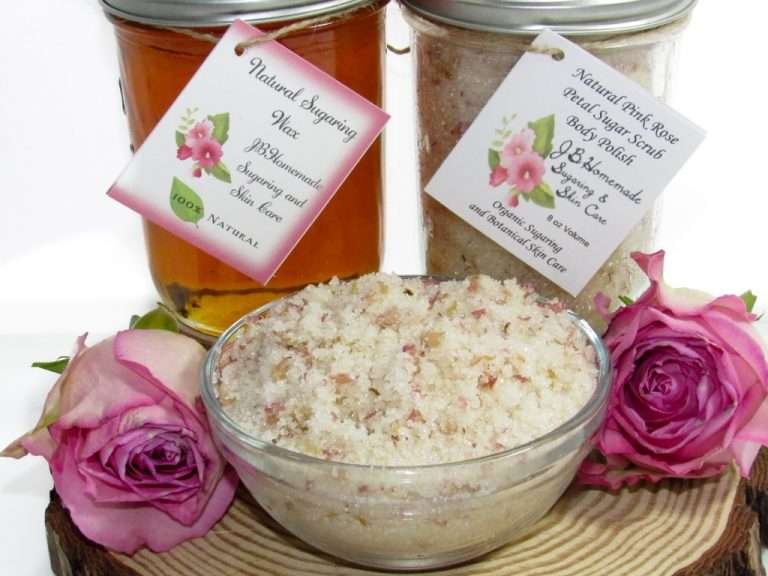 The set includes an 8 oz mason jar filled with soft sugaring wax, a jar of Pink Rose Petal Sugar Body Scrub, the included applicator, bottle of pure aloe vera, denims strips and a glass bowl showcasing the sugar scrub, garnished with a pink rose bloom.