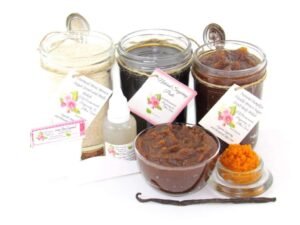 The bundle includes an 8 oz mason jar filled with firm sugaring paste, a jar of Pumpkin Vanilla Brown Sugar Body Scrub, and Colloidal Oatmeal Brown Sugar Dry Body Scrub, a small bottle of pure aloe vera, a pouch of cornstarch, an applicator, and a glass bowl showcasing the sugar scrub, garnished with a vanilla bean and pumpkin puree.