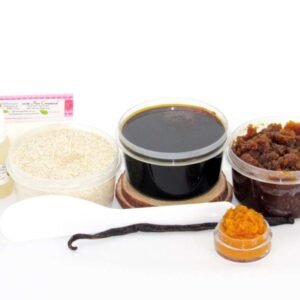 The home sugaring hair removal starter kit comes with a 2 oz tub of firm sugaring paste, a tub of Pumpkin Vanilla Brown Sugar Body Scrub, and a tub of Colloidal Oatmeal Brown Sugar Dry Body Scrub, a small bottle of pure aloe vera, a pouch of cornstarch, an applicator, and the pristine white surface is garnished with a vanilla bean and pumpkin puree.