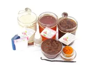 The bundle includes an 8 oz mason jar filled with soft sugaring wax, a jar of Pumpkin Vanilla Brown Sugar Body Scrub, and Colloidal Oatmeal Brown Sugar Dry Body Scrub, a small bottle of pure aloe vera, a pouch of cornstarch, denim strips, an applicator, and a glass bowl showcasing the sugar scrub, garnished with a vanilla bean and pumpkin puree.