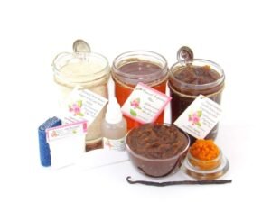 The bundle includes an 8 oz mason jar filled with soft sugaring wax, a jar of Pumpkin Vanilla Brown Sugar Body Scrub, and Colloidal Oatmeal Brown Sugar Dry Body Scrub, a small bottle of pure aloe vera, a pouch of cornstarch, denim strips, an applicator, and a glass bowl showcasing the sugar scrub, garnished with a vanilla bean and pumpkin puree.