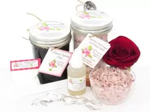 The bundle includes an 8 oz mason jar filled with firm sugaring paste, a jar of Red Rose Petal Sugar Body Scrub, a small bottle of pure aloe vera, a pouch of cornstarch, an applicator, and a glass bowl showcasing the sugar scrub, garnished with a red rose bloom.