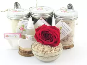 The bundle includes an 8 oz mason jar filled with firm sugaring paste, a jar of Red Rose Petal Sugar Body Scrub, and Colloidal Oatmeal Brown Sugar Dry Body Scrub, a small bottle of pure aloe vera, a pouch of cornstarch, an applicator, and a glass bowl showcasing the sugar scrub, garnished with a red rose bloom.