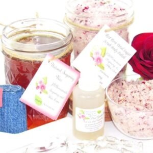 The bundle includes an 8 oz mason jar filled with soft sugaring wax, a jar of Red Rose Petal Sugar Body Scrub, the included applicator, bottle of pure aloe vera, denims strips and a glass bowl showcasing the sugar scrub, garnished with a red rose bloom.