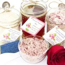 The bundle includes an 8 oz mason jar filled with soft sugaring wax, a jar of Red Rose Petal Sugar Body Scrub, and Colloidal Oatmeal Brown Sugar Dry Body Scrub, a small bottle of pure aloe vera, a pouch of cornstarch, denim strips, an applicator, and a glass bowl showcasing the sugar scrub, garnished with a red rose bloom.