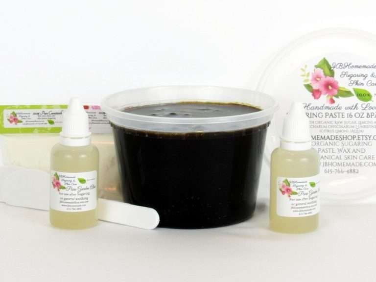 A 16-ounce tub of JBHomemade Sugaring Paste is presented with its included pouches of cornstarch, bottles of aloe vera and applicators.