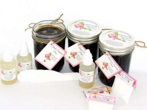 Three 8 oz masons (24 oz) of JBHomemade Sugaring Paste are presented with its included pouches of cornstarch, bottles of aloe vera and applicators.