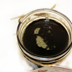 an overhead view of sugaring paste hair removal in a glass mason jar
