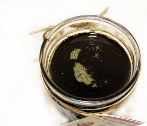 an overhead view of sugaring paste hair removal in a glass mason jar