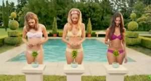 A funny image of three girls wearing bikinis standing behind green bush plants in pots in front of a pool. The girls have scissors in their hands and the message is to 'trim their bush' before sugaring hair removal if their hairs are longer than 1/4" or sugaring will hurt way worse.