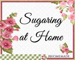 Hollyhock Logo for JBHomemade Sugaring and Skin Care with pink and green elements framing a title of ‘Sugaring at Home'