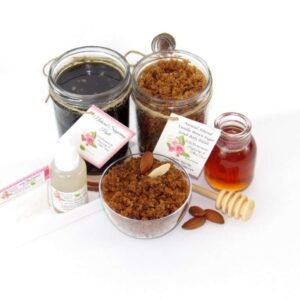 The bundle includes an 8 oz mason jar filled with firm sugaring paste, a jar of Almond Vanilla Brown Sugar Body Scrub, a small bottle of pure aloe vera, a pouch of cornstarch, an applicator, and a glass bowl showcasing the sugar scrub, garnished with sprinkled almonds and a small glass jar of raw honey.