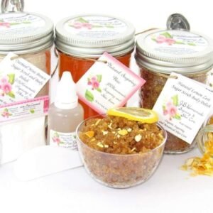 A bundle featuring an 8 oz mason jar of softer consistency sugaring wax, flanked by jars of Lemon Zest Cane Sugar Body Scrub and Colloidal Oatmeal Brown Sugar Dry Body Scrub, a small bottle of pure aloe vera, a pouch of cornstarch, denim strips, an applicator, with a spilled jar of dried lemon zest and a bowl of the body scrub adorned with a lemon slice.