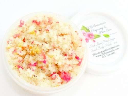 Discover a 2 oz tub of soft pink rose petal cane sugar scrub, subtly fragranced and ideal for treating your skin.