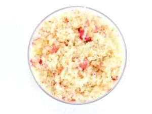 A glass bowl of JBHomemade Sugaring and Skin Care's Natural Pink Rose Petal Floral Sugar Body Scrub.